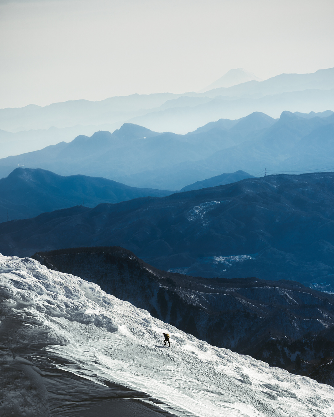 A Mountaineering Man is Going Up Alone